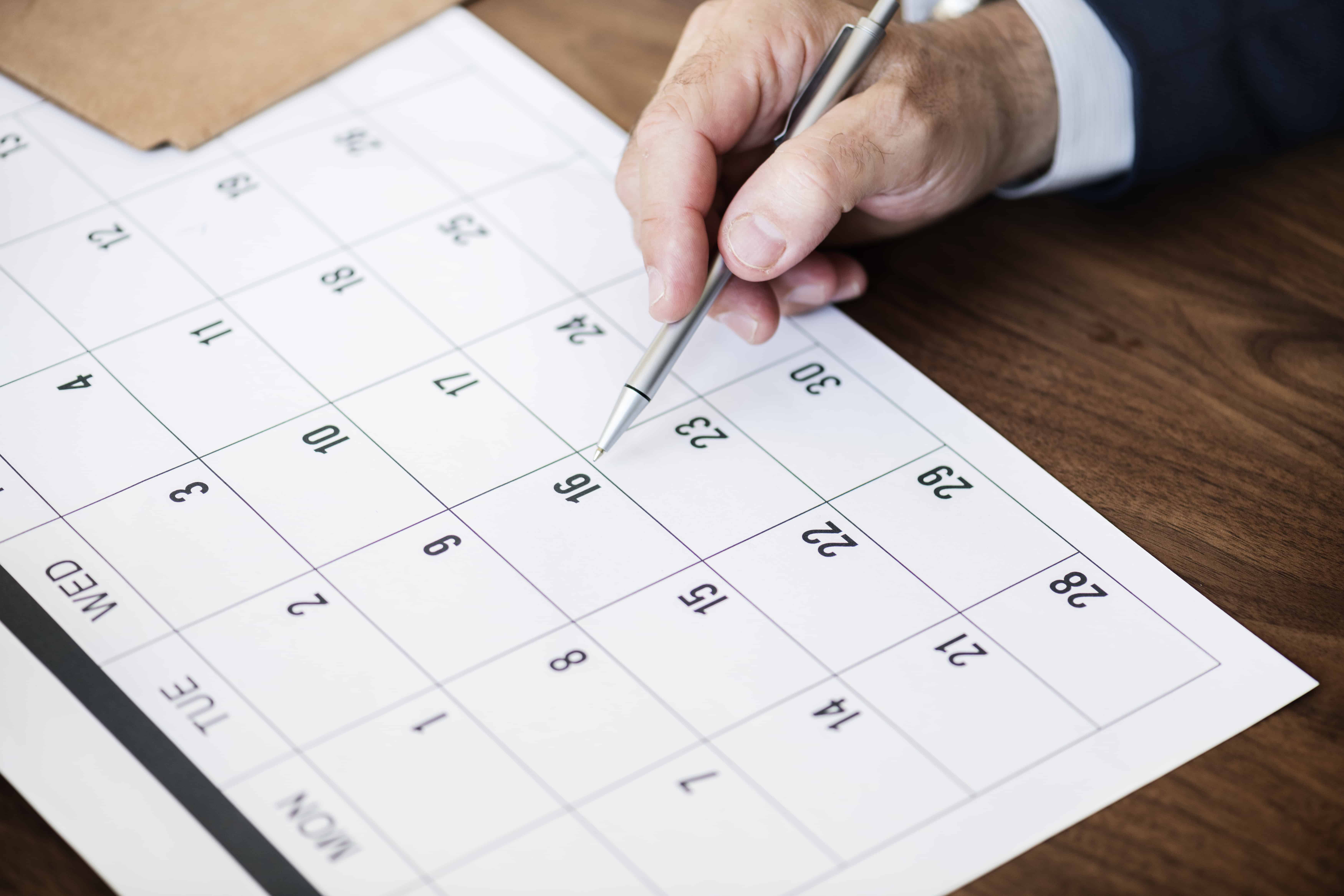 Businessman marking on calendar for an appointment